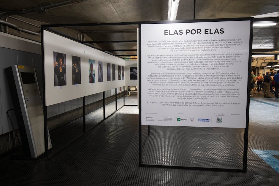 Interior view of a contemporary photography exhibition with descriptive text panel and portraits.